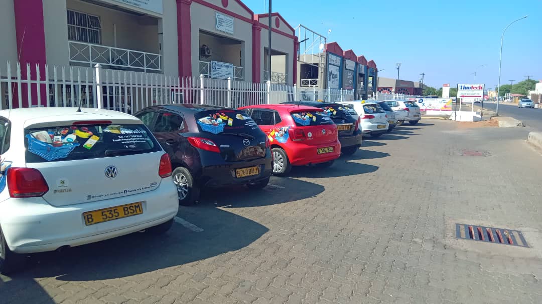 Double A. G branded vehicles parked in a row on the street