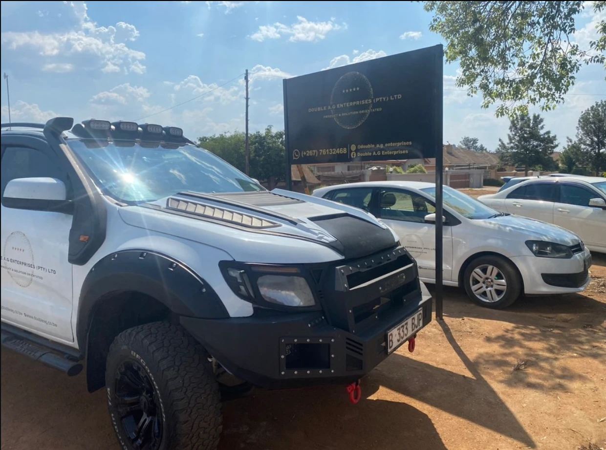 Ford Ranger parked beside the Double A. G Enterprises signage board