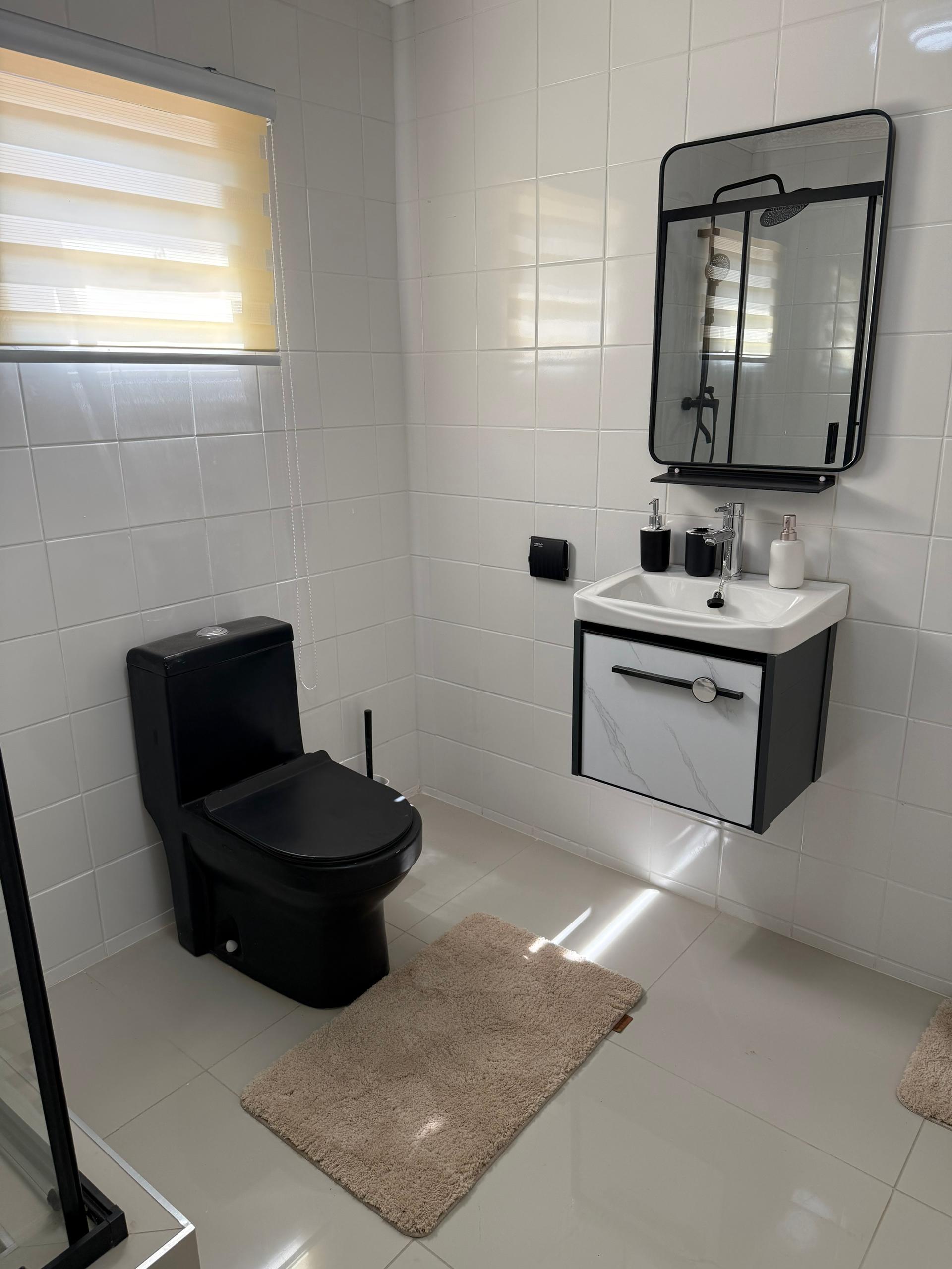 Bathroom with vanity and mirror